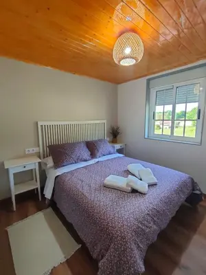 a bedroom with a large bed with two pillows on it at Casa Telmo in Acova