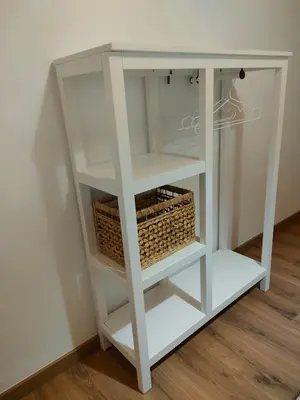 a white book shelf with a basket on it at Casa Telmo in Acova