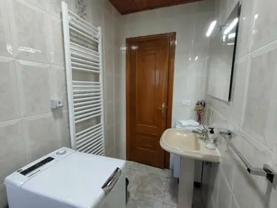 a white bathroom with a toilet and a sink at Casa Telmo in Acova