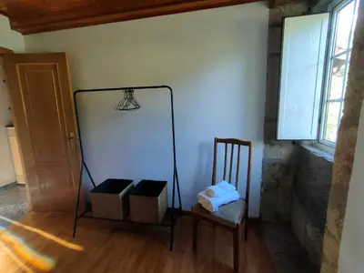 a room with a mirror and a chair and a window at Casa Telmo in Acova