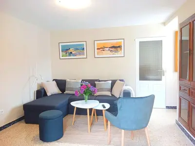 a living room with a blue couch and a table at Casa Calvo in Vivero