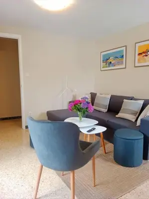 a living room with a couch and a table with flowers at Casa Calvo in Vivero