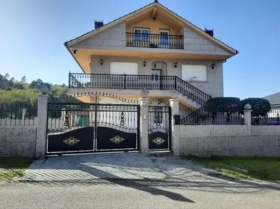 a house with a gate in front of it at Fogar dos Petellos, Mondariz. in Mondariz