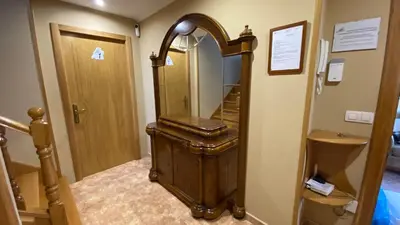 a hallway with a large mirror and a stairway at DESPERTAR CON EL SONIDO DE LOS PÁJAROS in Melide