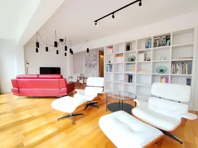 a living room with a red couch and white chairs at Arq Plaza Mayor in Viveiro