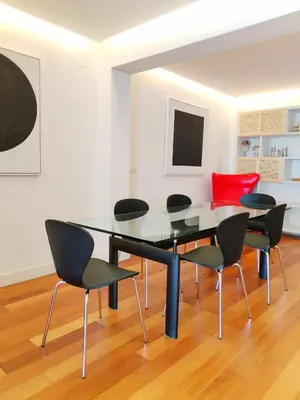 a dining room with a glass table and chairs at Arq Plaza Mayor in Viveiro