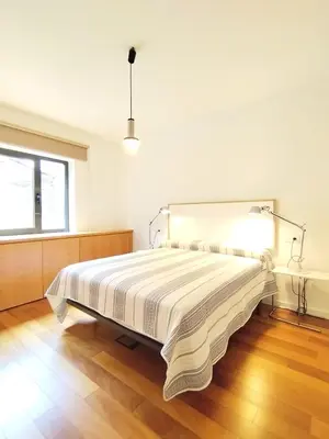 a bedroom with a bed with a striped bedspread at Arq Plaza Mayor in Viveiro
