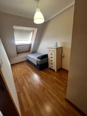 a bedroom with a bed and a dresser in a room at Duplex Playa de Foz in Foz
