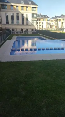 a large swimming pool in front of a building at Duplex Playa de Foz in Foz