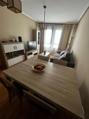 a living room with a table and a couch at Duplex Playa de Foz in Foz