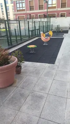 a playground with two benches and a playground at Duplex Playa de Foz in Foz