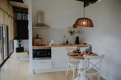 a kitchen with a table and chairs and a sink at Casal Oseira in Ourense