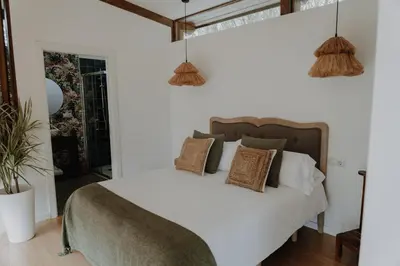 a bedroom with a white bed with pillows at Casal Oseira in Ourense