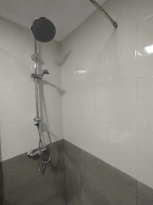 a shower with a shower head in a bathroom at Marsán in Arzúa