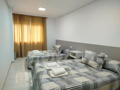 a hotel room with two beds and a couch at Marsán in Arzúa