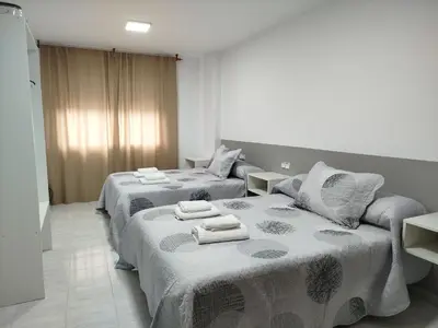 two beds in a hotel room with towels on them at Marsán in Arzúa