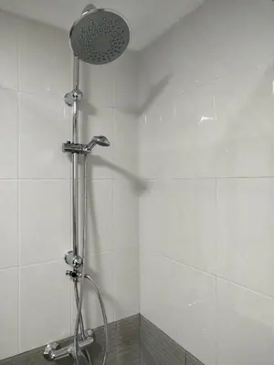 a shower with a shower head in a bathroom at Marsán in Arzúa