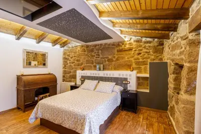 a bedroom with a bed and a piano at Casapepe in Nogueira de Ramuin