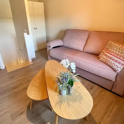 a living room with a couch and a table at Casa la florida in Puebla de Sanabria