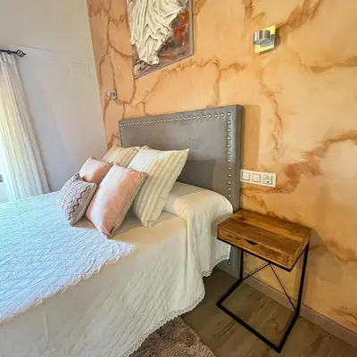 a bedroom with a bed with pillows on it at Casa la florida in Puebla de Sanabria