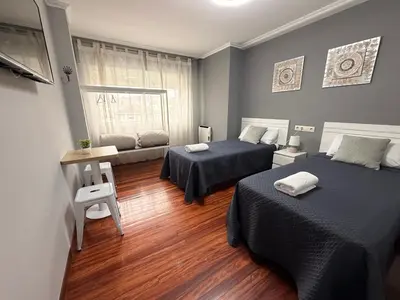a hotel room with two beds and a window at O Loureiro - Grupo Arcanos in Caldas de Reis