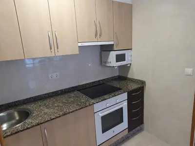 a small kitchen with a sink and a microwave at Mirasol in Viveiro