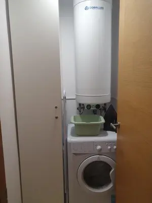 a washing machine with a bowl on top of it at Mirasol in Viveiro