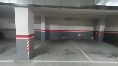 an empty parking garage with red and white columns at Mirasol in Viveiro