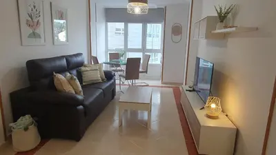 a living room with a couch and a table at Mirasol in Viveiro