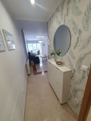 a hallway with a mirror and a dresser in a room at Mirasol in Viveiro