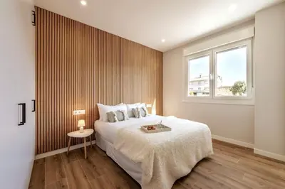 a bedroom with a large bed and a window at White Tree Rooms and Apartments in O Pedrouzo