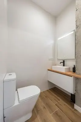 a white bathroom with a toilet and a sink at White Tree Rooms and Apartments in O Pedrouzo