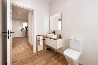 a white bathroom with a toilet and a sink at White Tree Rooms and Apartments in O Pedrouzo