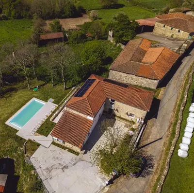 a bedroom with a large bed and a television at Reverence Villas Caldelas in Antas de Ulla