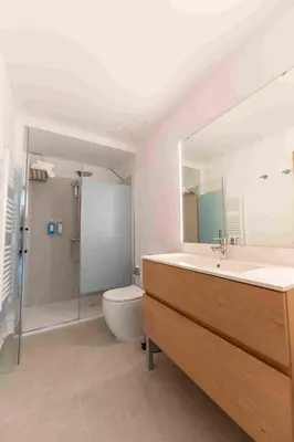 a bedroom with two beds and a desk in it at Reverence Villas Caldelas in Antas de Ulla