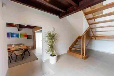 a dining room with a table and a staircase at Reverence Villas Caldelas in Antas de Ulla