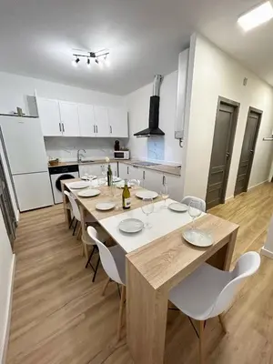 a dining room with a table and chairs in a kitchen at Catapiro - Confort Elegante y Exclusivo en el Corazón de la Ciudad in Ourense