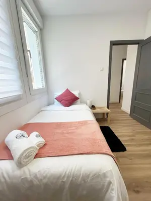 a bedroom with two beds and a window at Catapiro - Confort Elegante y Exclusivo en el Corazón de la Ciudad in Ourense