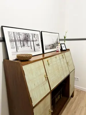 a wooden dresser with two pictures on top of it at Catapiro - Confort Elegante y Exclusivo en el Corazón de la Ciudad in Ourense
