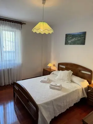 a bedroom with a bed with two towels on it at Triacastela Sunset Terrace in Tríacastela