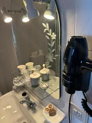 a bathroom with a sink with a mirror and a coffee maker at Triacastela Sunset Terrace in Tríacastela