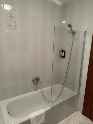 a shower with a glass door in a bathroom at Triacastela Sunset Terrace in Tríacastela