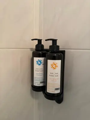 two bottles ofodorizers are sitting on a wall at Triacastela Sunset Terrace in Tríacastela