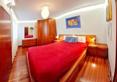 a bedroom with a large bed with red sheets at Villagalicia360 in Bergondo