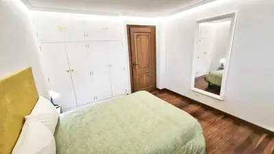 a small bedroom with a bed and a mirror at Villagalicia360 in Bergondo