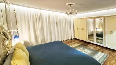 a living room with a blue bed and a chandelier at Villagalicia360 in Bergondo