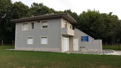 a small building with a sign in front of it at Cruz de Ferreira CAMINO PRIMITIVO Ferreira - Lugo in Palas de Rei