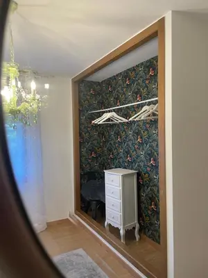 a room with a wall with a drawer and a dresser at A Casa de Buxacos in Arzúa