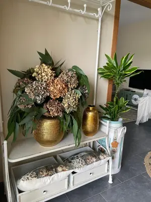 a shelf with two vases and flowers on it at A Casa de Buxacos in Arzúa