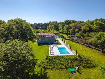 an aerial view of a house with a swimming pool at Reverence Villas Fufin in Monterroso